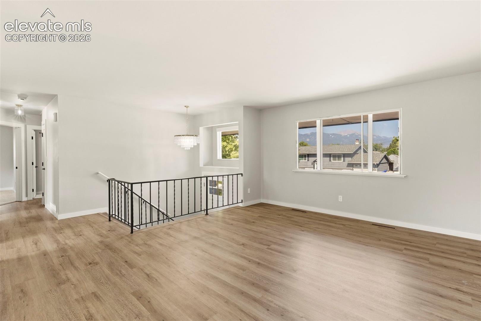 Spacious interior featuring luxury vinyl plank flooring and Pikes Peak views