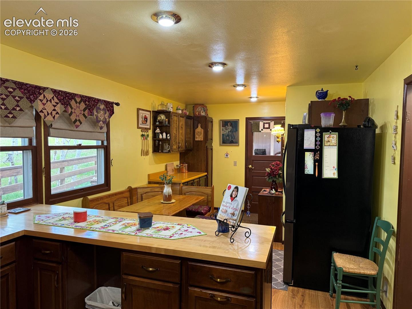 Kitchen featuring wood-finish flooring, recessed ceiling lighting, and a built-in dining nook
