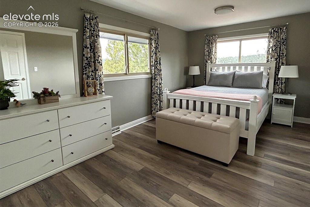 Private primary bedroom with walk in closet, balcony and full, en suite bathroom