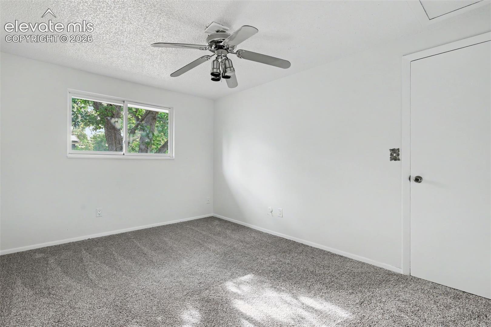  Secondary bedroom with natural light and closet storage.