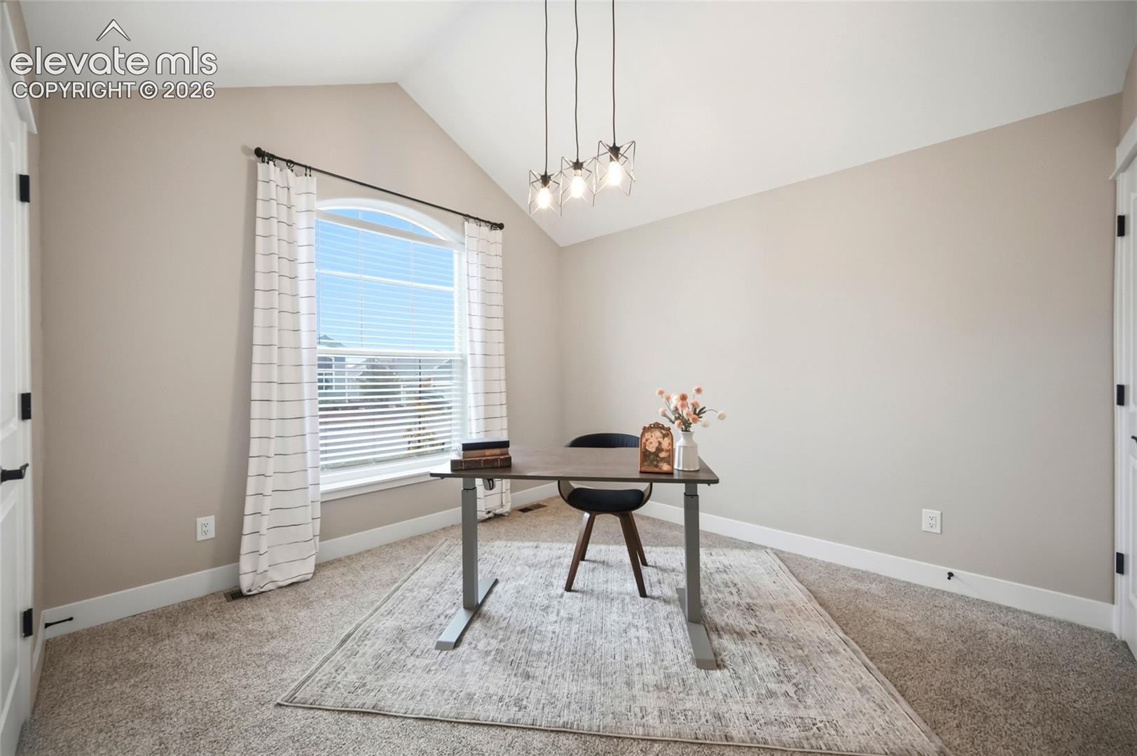 Vaulted ceilings, arched window with integrated blinds, and three-light geometric pendant fixture