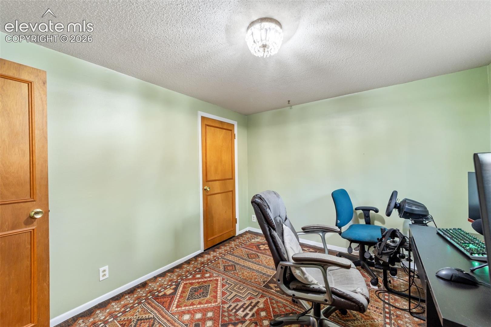 Room with light green painted walls and two paneled wood doors