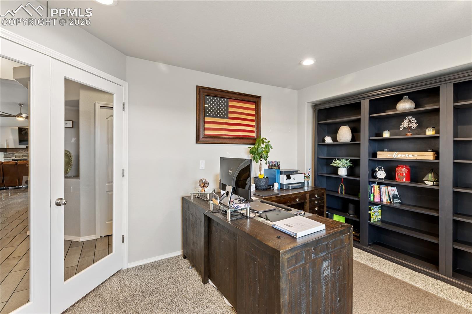 Dedicated office space with French doors, custom built-ins, and room for working