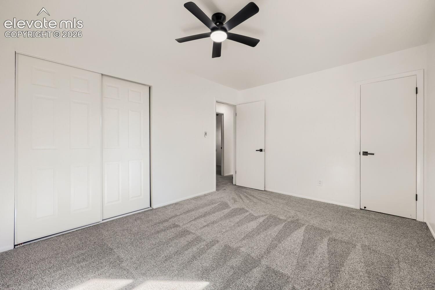White walls with grey patterned carpeting