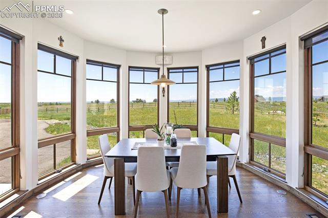 Charming eat-in nook with curved bay windows and sweeping views of the open meadow and private acreage.