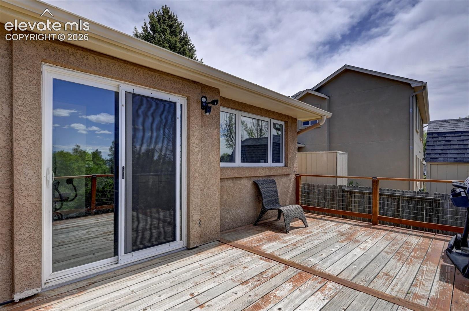 Expansive outdoor deck featuring wood flooring and a wooden railing
