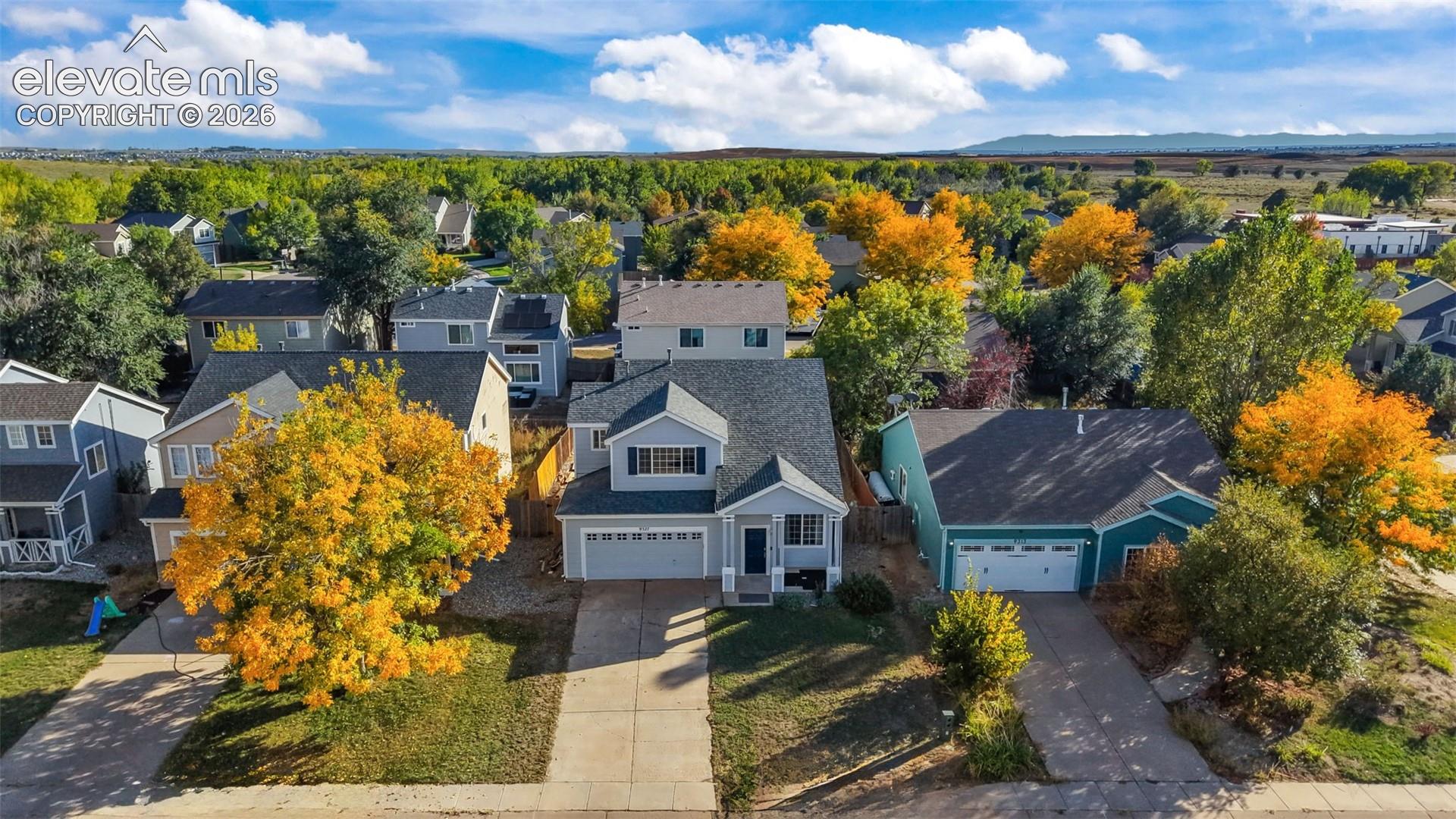 Two-story residence with a two-car garage, front-facing dormer, and a covered entry