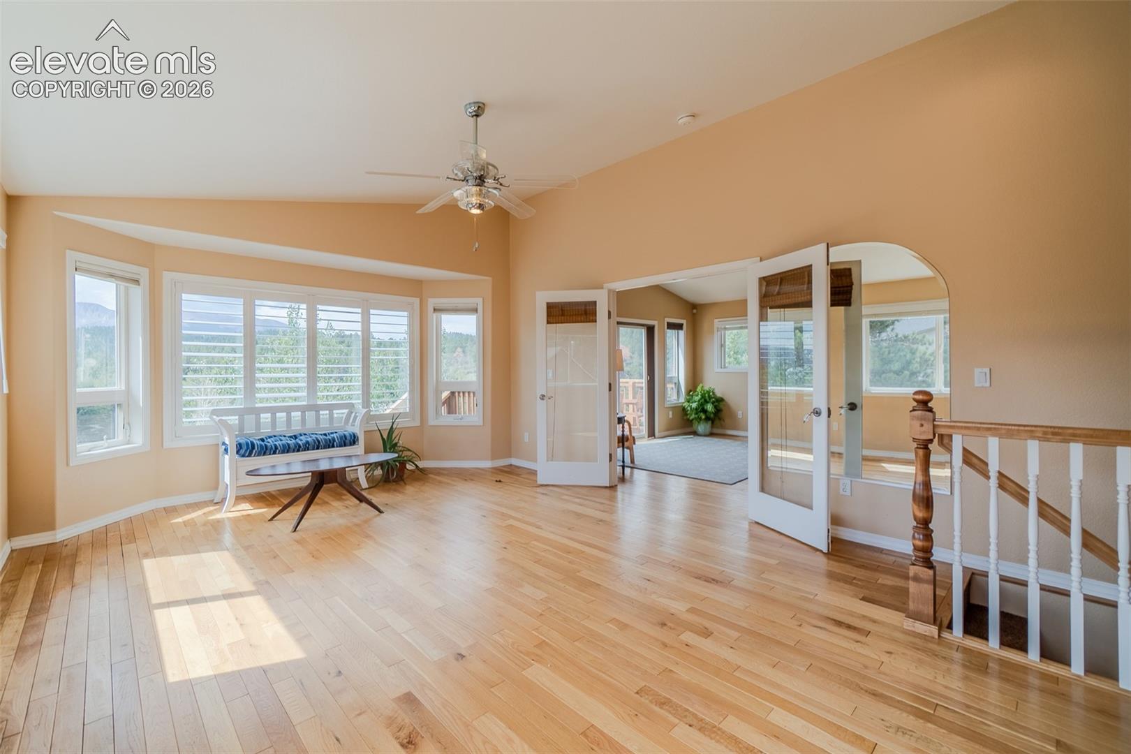 Spacious primary suite filled with natural light and large windows showcasing beautiful mountain views.