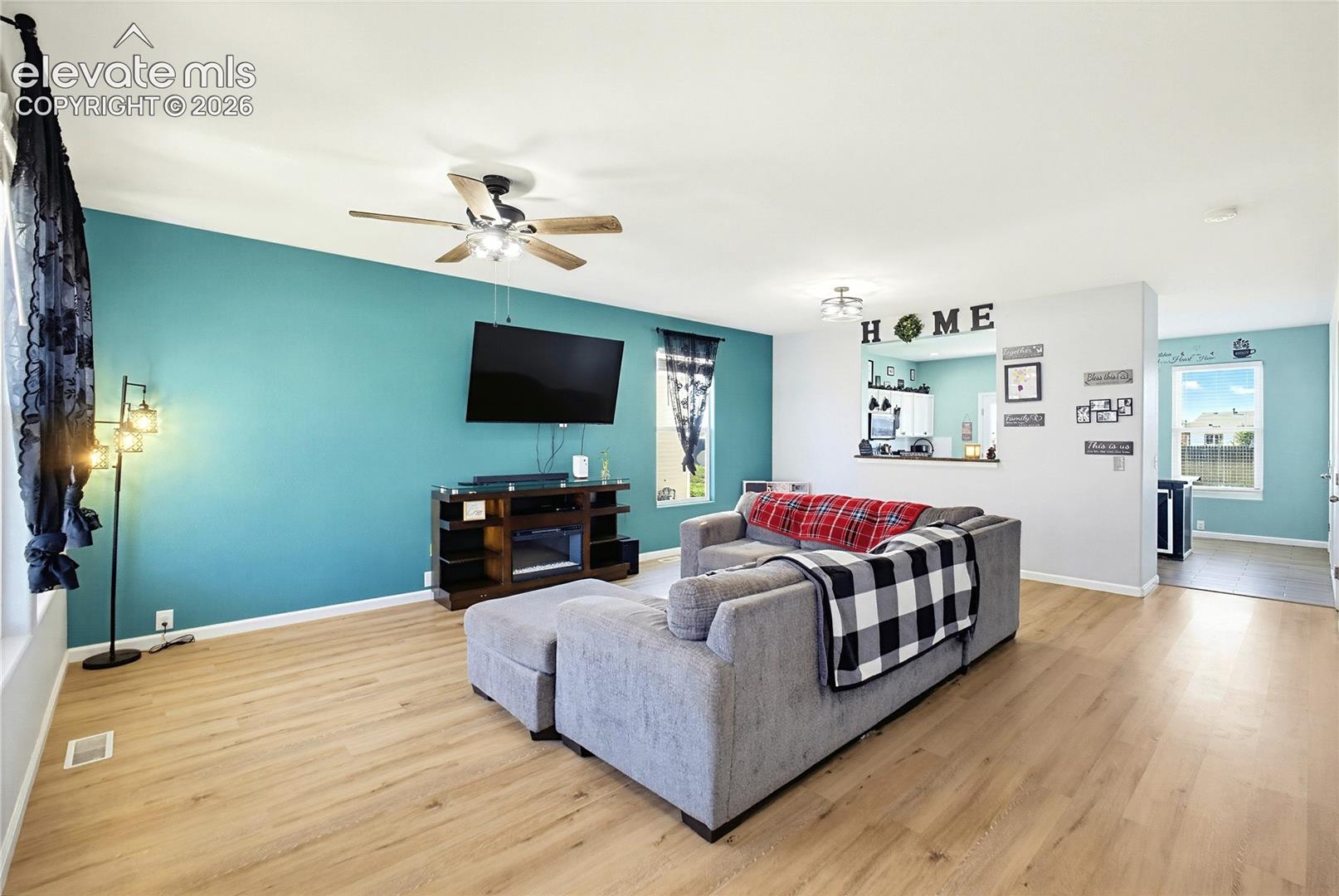 Open-concept living area featuring wood-finish flooring