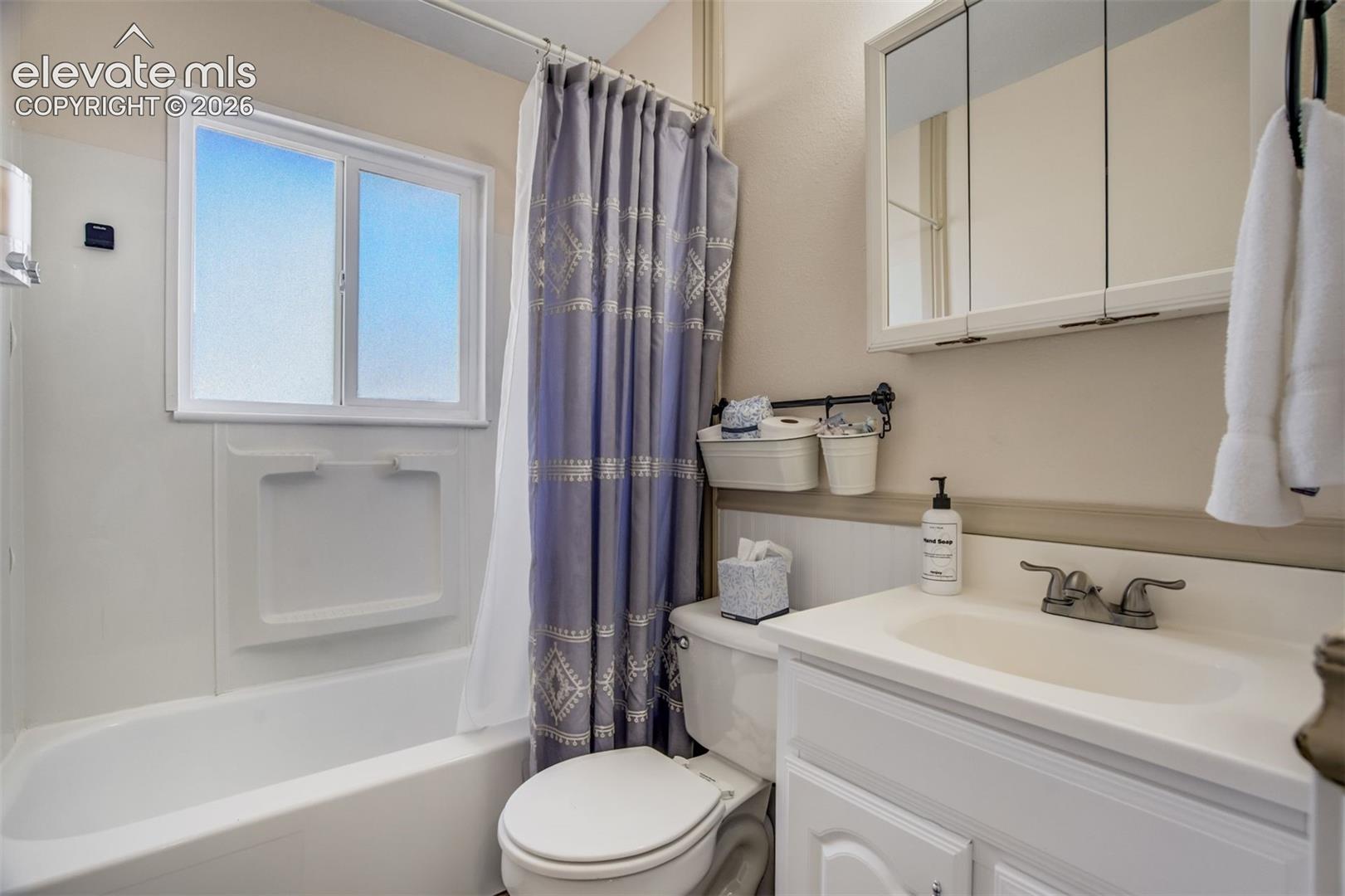 White vanity with an integrated sink and dual-handle faucet