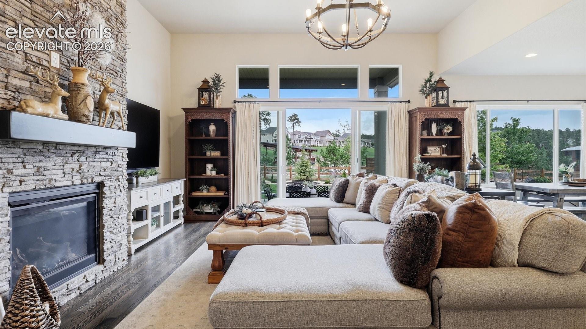 SOARING SOPHISTICATION — Dramatic 13-foot ceilings elevate this stunning living room, creating an impressive sense of openness, light, and luxury.