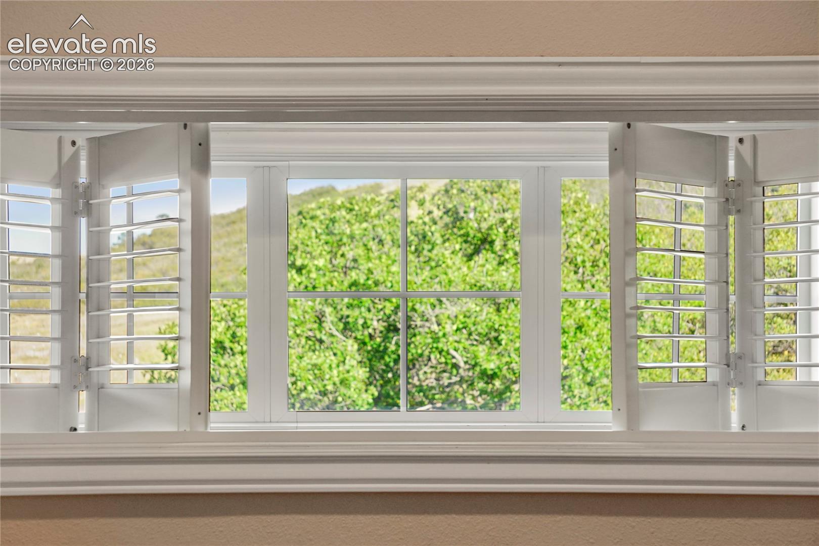 Long windows through breezeway allow mountain views on the upper landing