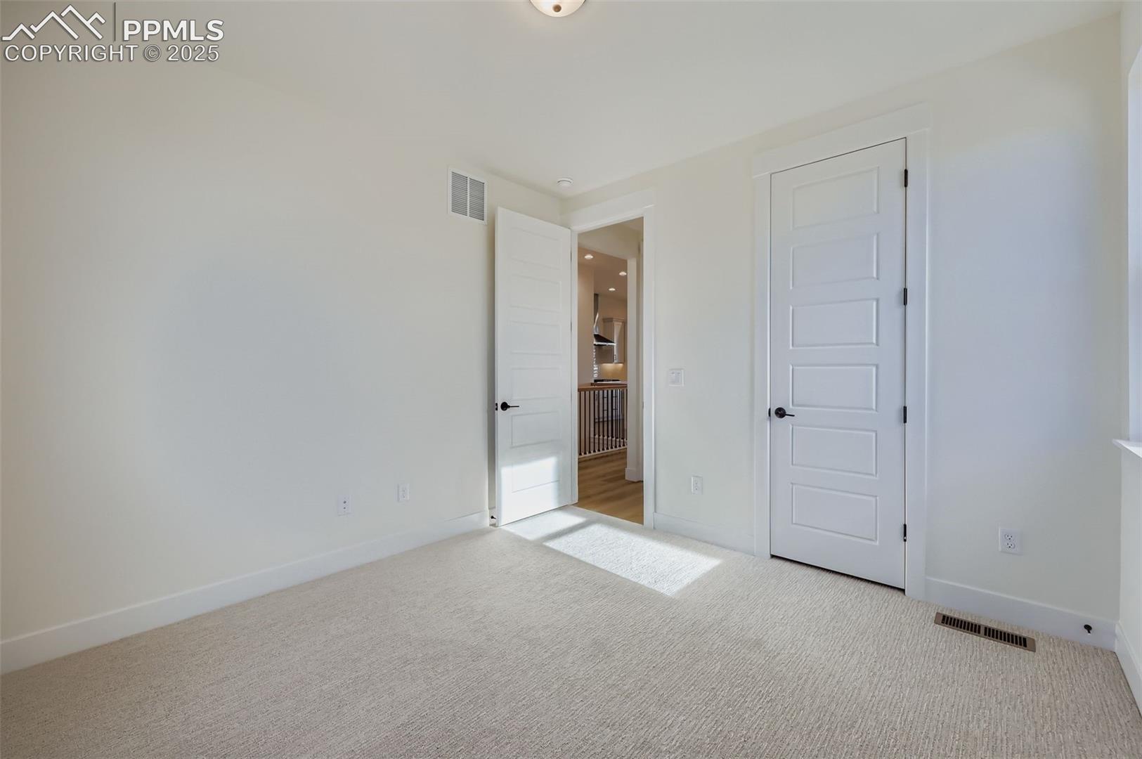 Unfurnished bedroom featuring carpet and a closet