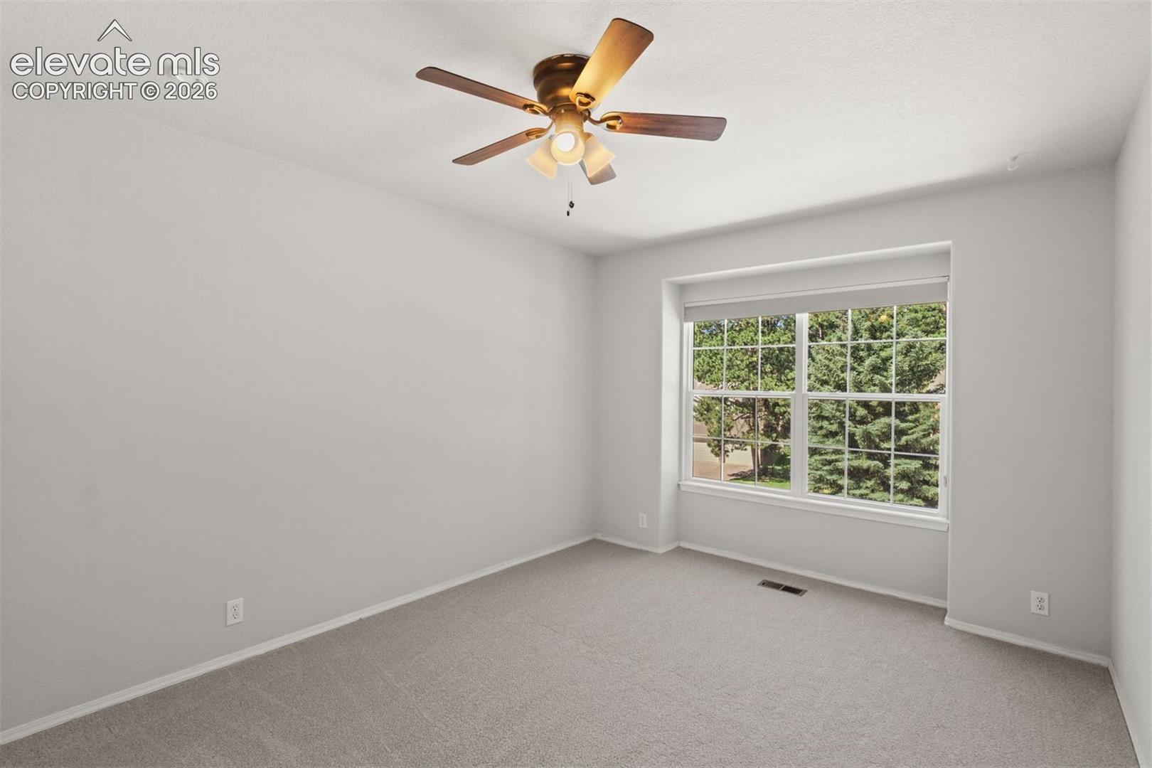 Upstairs bedroom with ceiling fan