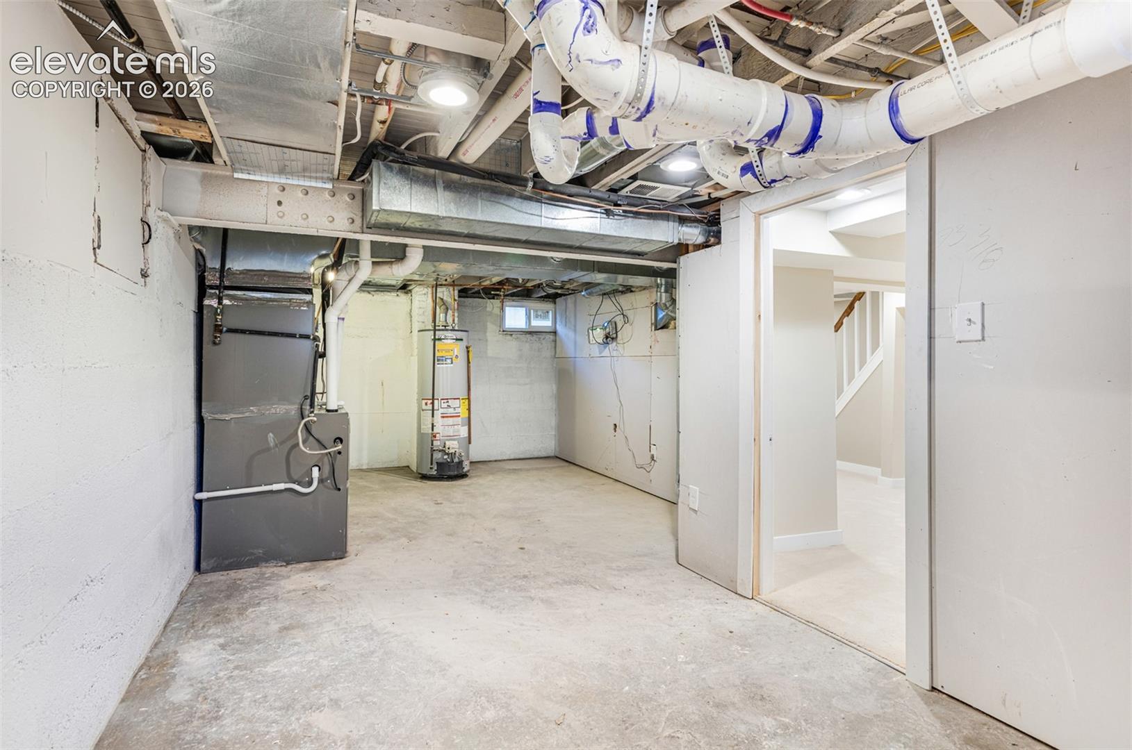 Unfinished basement space with concrete flooring