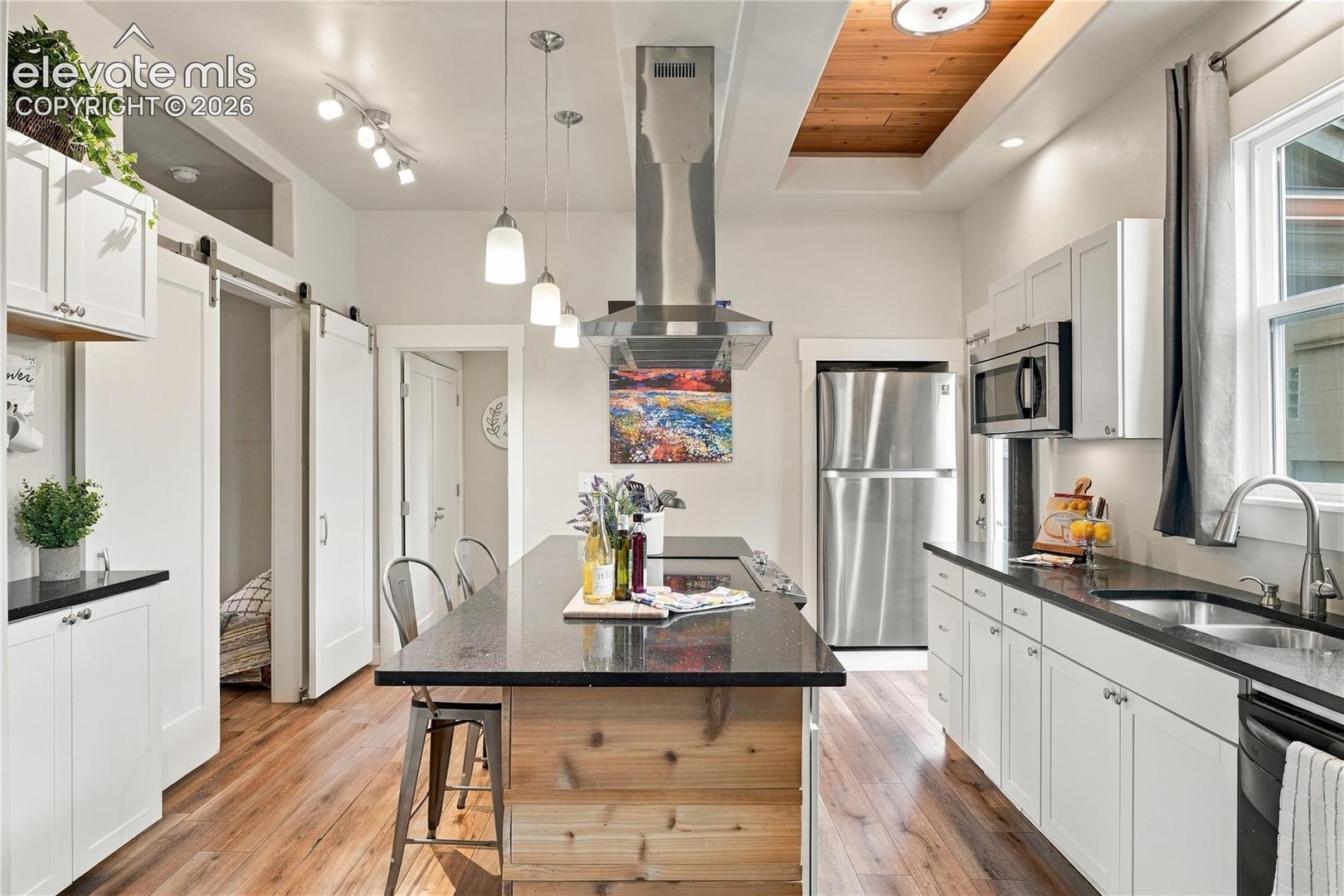 Well equipped kitchen with large island, breakfast bar and coffered ceilings.