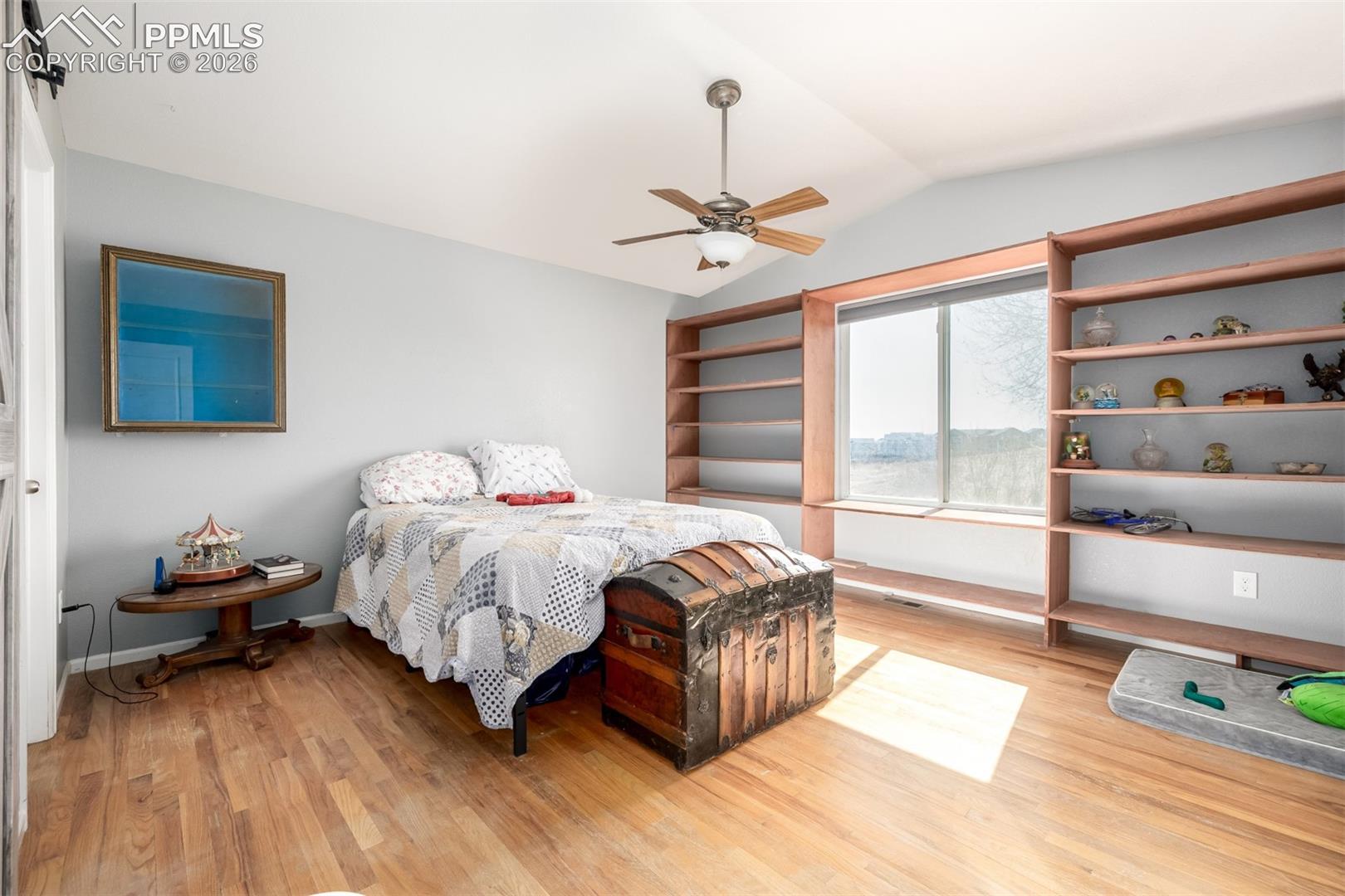 Main Level Primary Suite with Built In Books Cases overlooking the open space