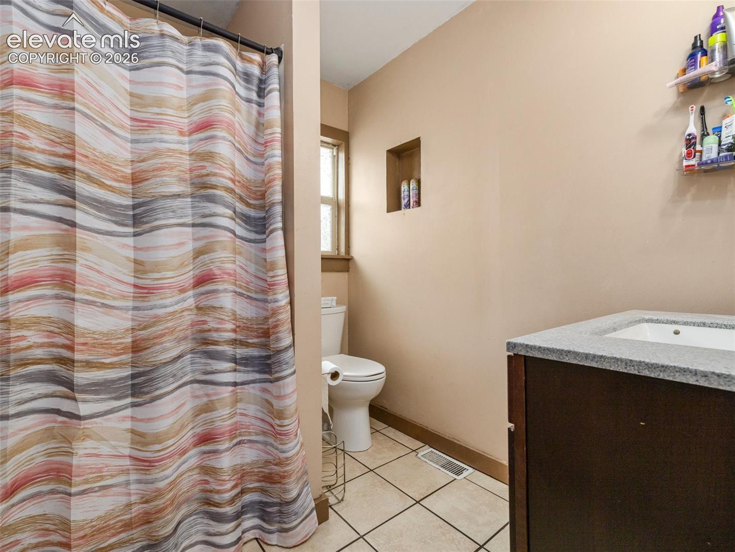 Built-in vanity with a rectangular sink and light-colored countertop