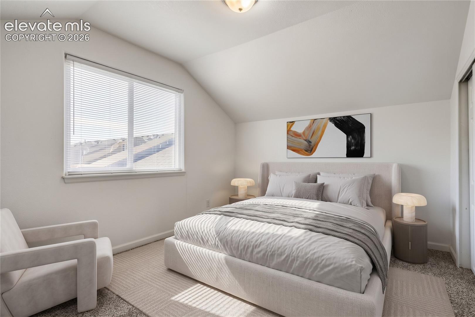 Bedroom featuring vaulted ceilings, neutral carpeting, and a large window with white blinds