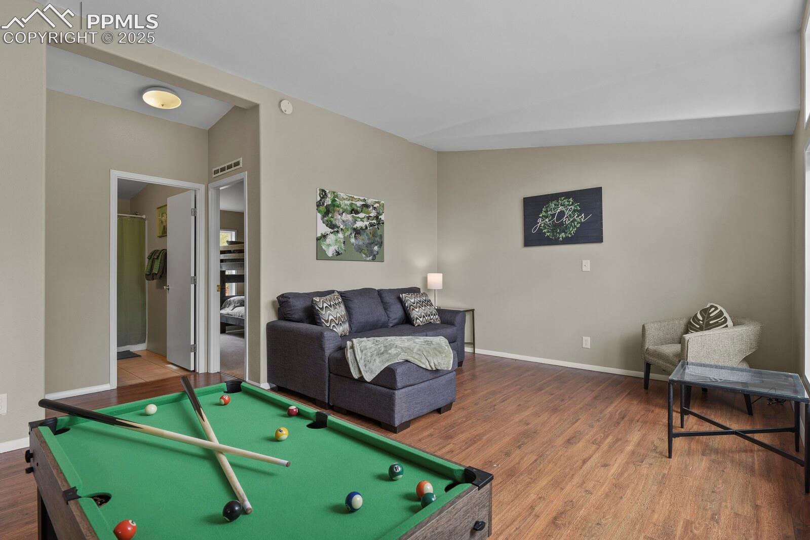 Rec room featuring pool table, wood finished floors, and lofted ceiling