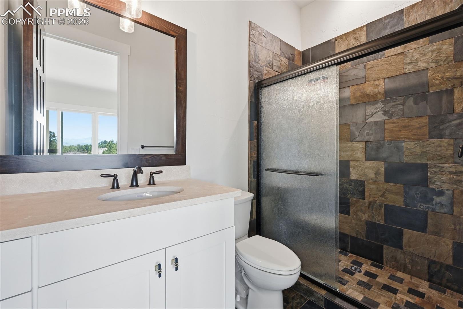 Bathroom with a stall shower and vanity