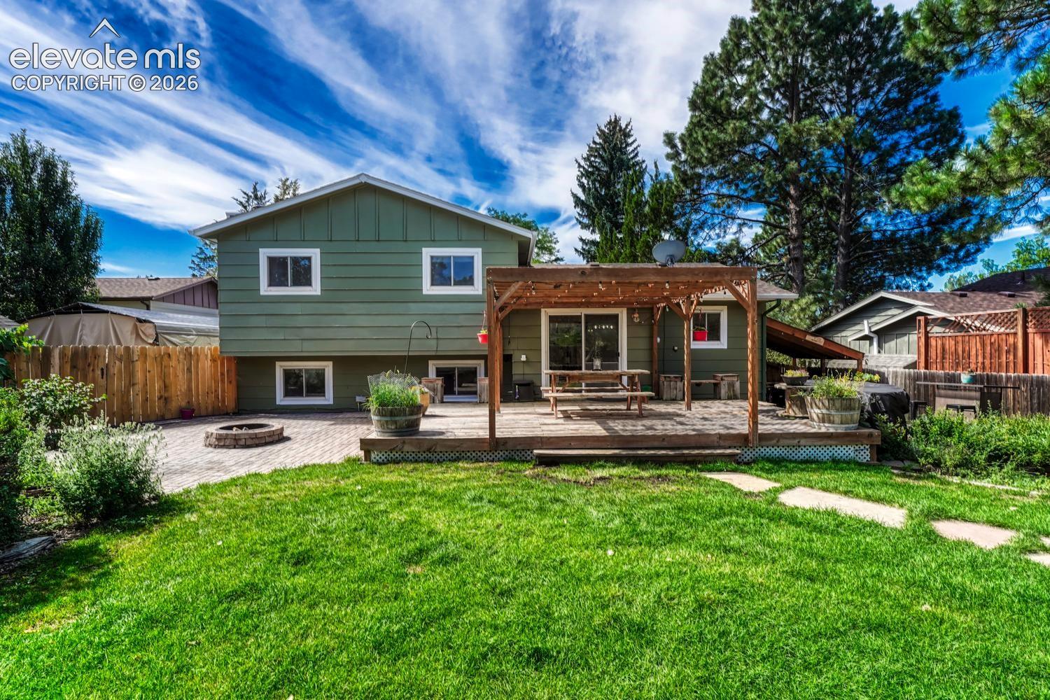 The fenced backyard is a fabulous sanctuary that features mature landscaping, multiple patio areas, a fire pit, hot tub, tranquil water feature, chicken coop, raised garden beds, & a garden shed. 