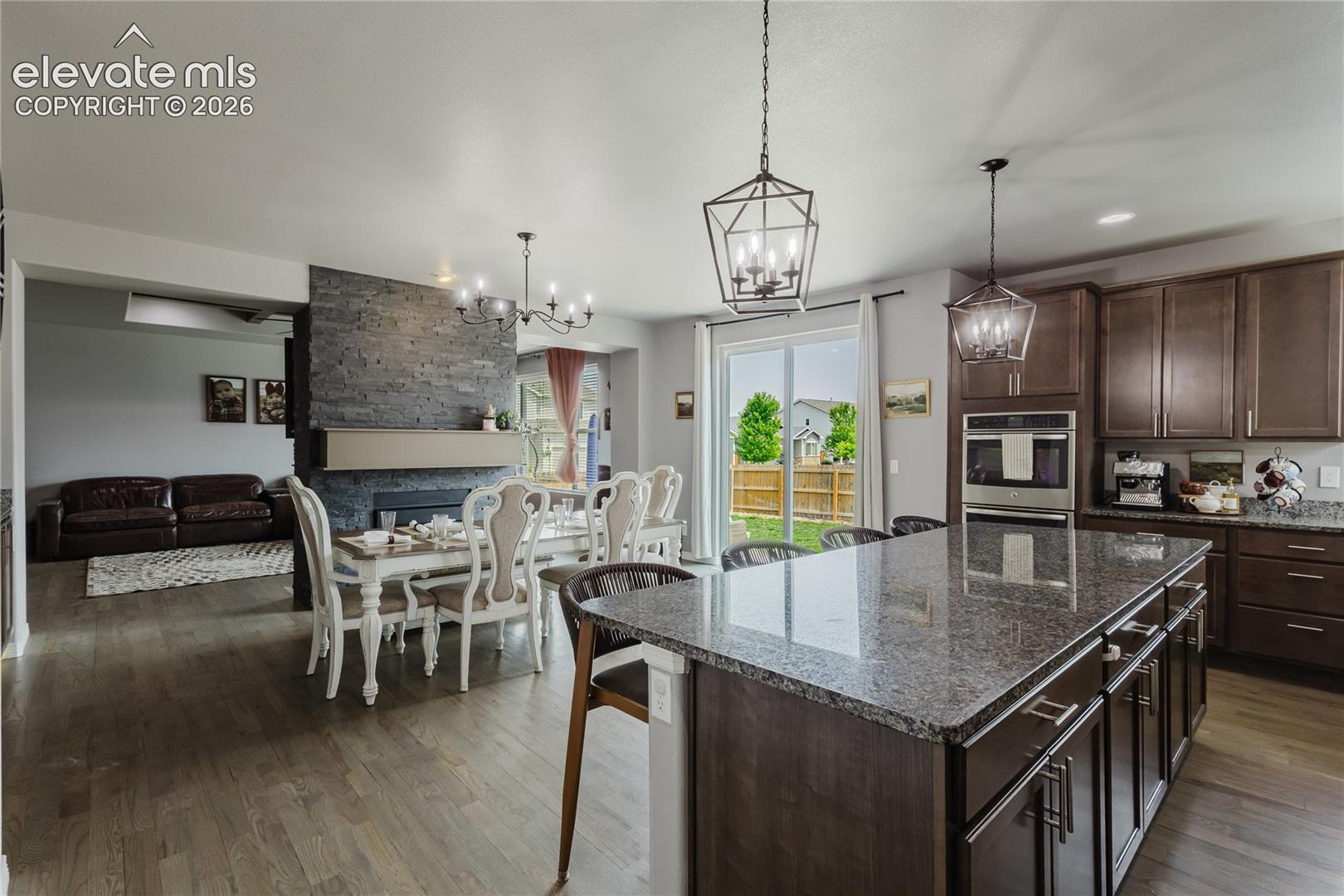 Kitchen featuring wood-finish flooring and a central island with a granite-style countertop