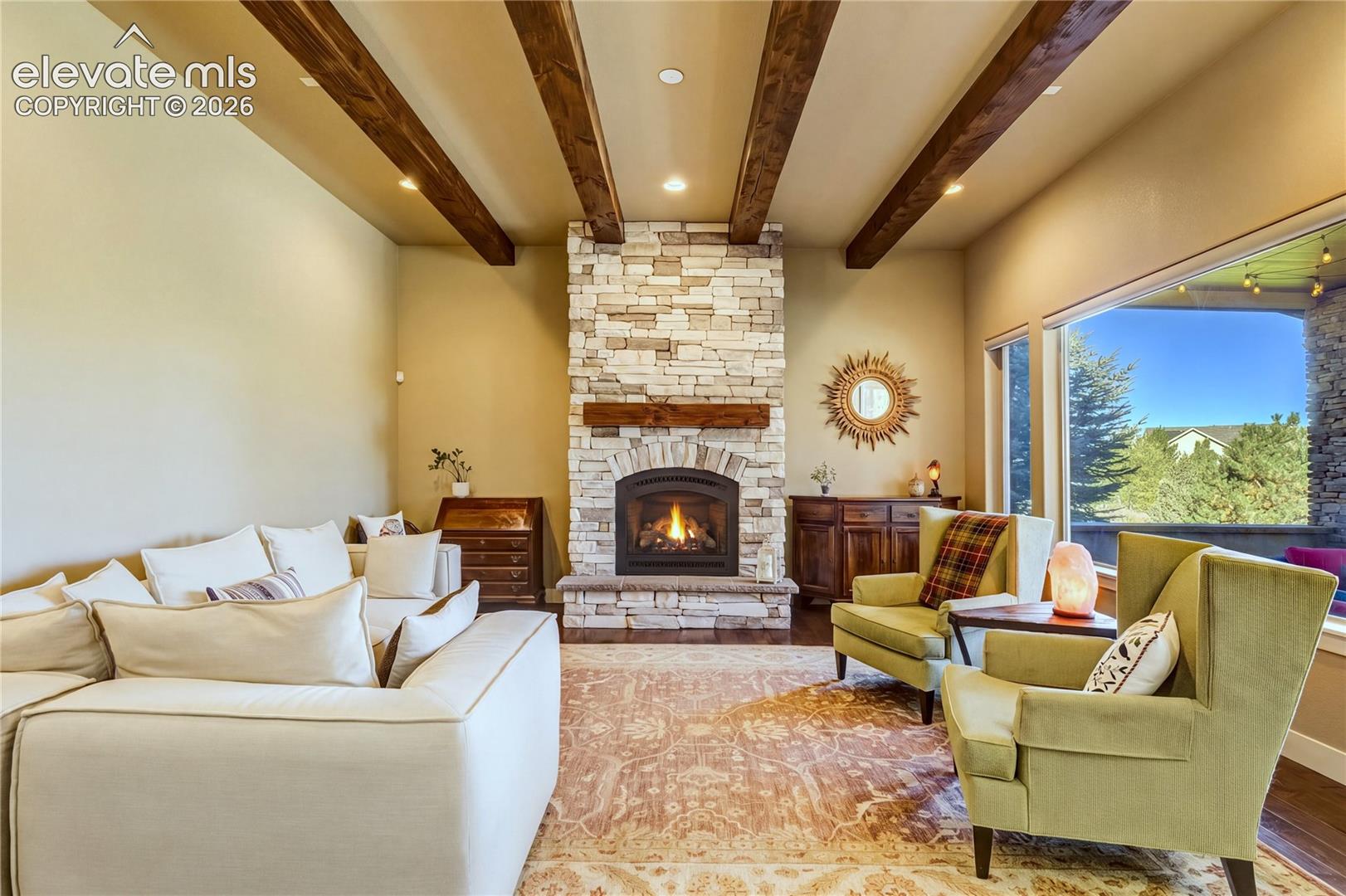 Gather around the impressive stone fireplace, where rich architectural textures, exposed ceiling beams + a thoughtfully proportioned seating area create a sophisticated yet comfortable retreat for quiet Colorado evenings.