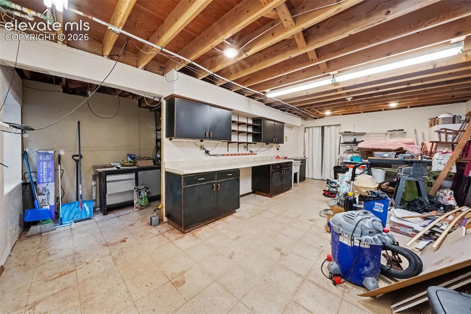 Large basement workshop offers generous space for projects, hobbies, tools, and equipment, with motion lighting for added convenience and functionality