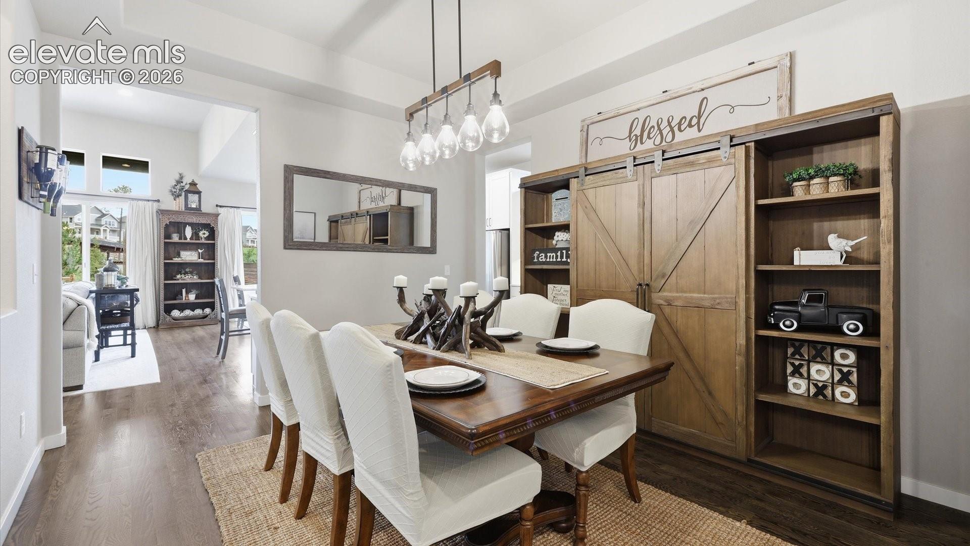 EFFORTLESSLY CONNECTED — An elegant dining space perfectly positioned between the kitchen and living room, creating a seamless flow for entertaining and everyday luxury.