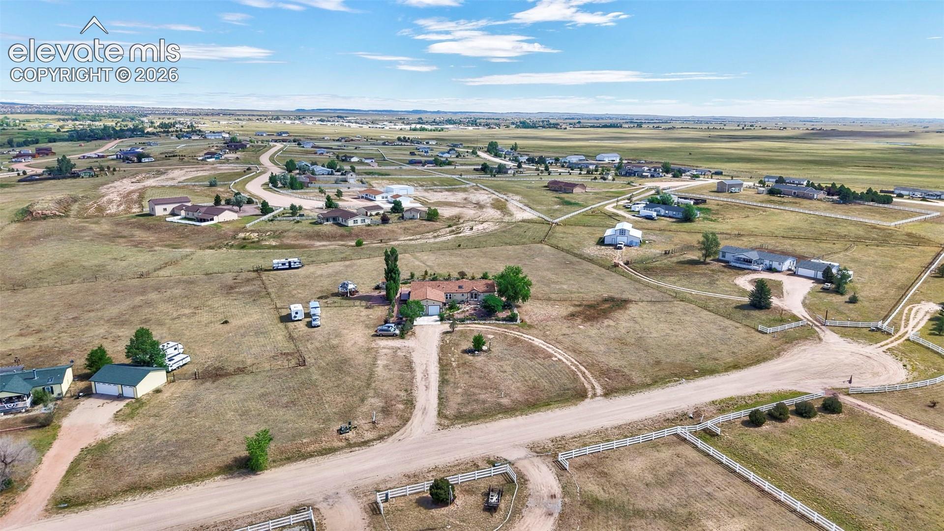 Expansive rural landscape featuring scattered residences and extensive open land