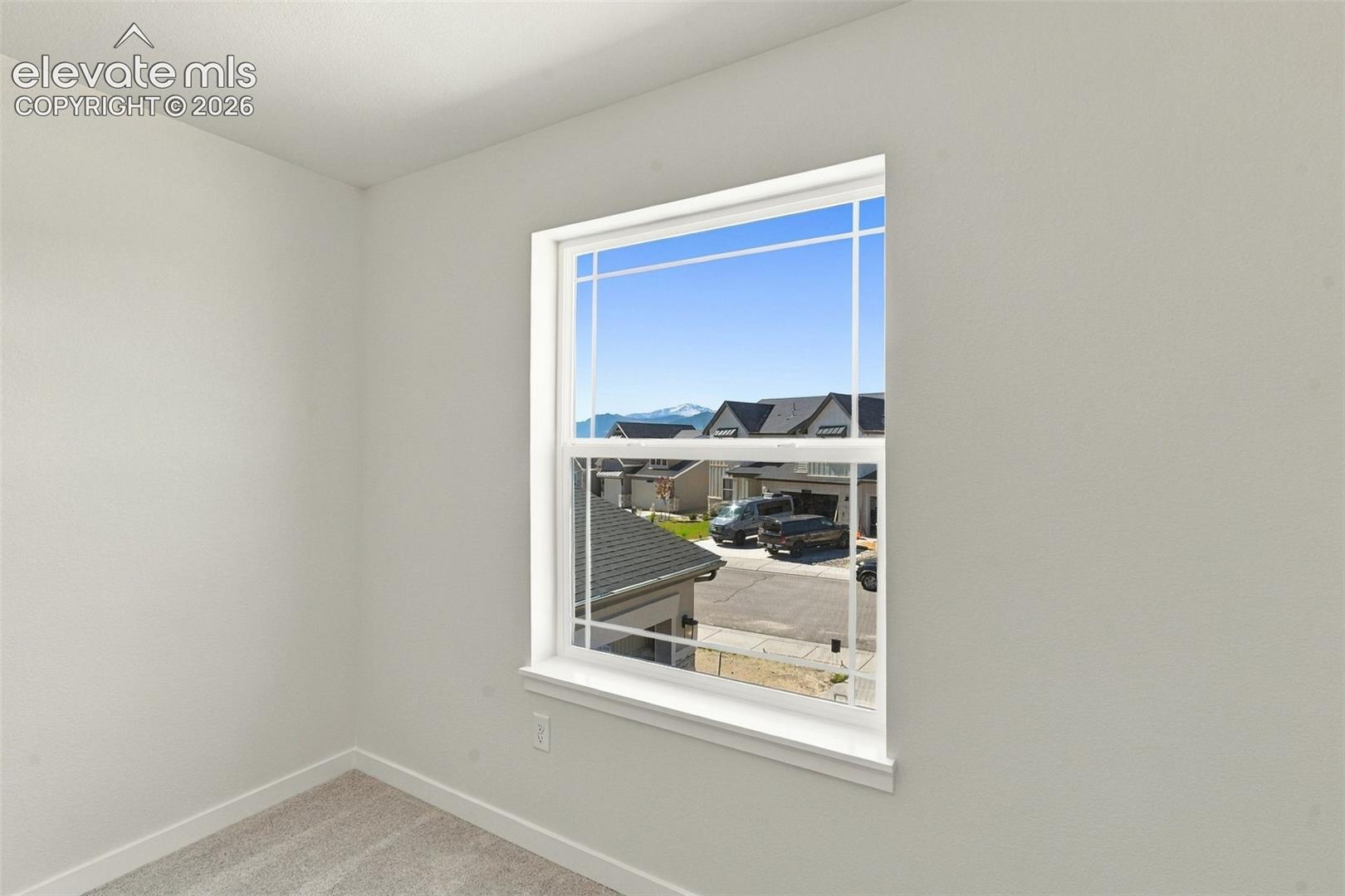 Bedroom 4 features with soft white walls and plush gray carpeting