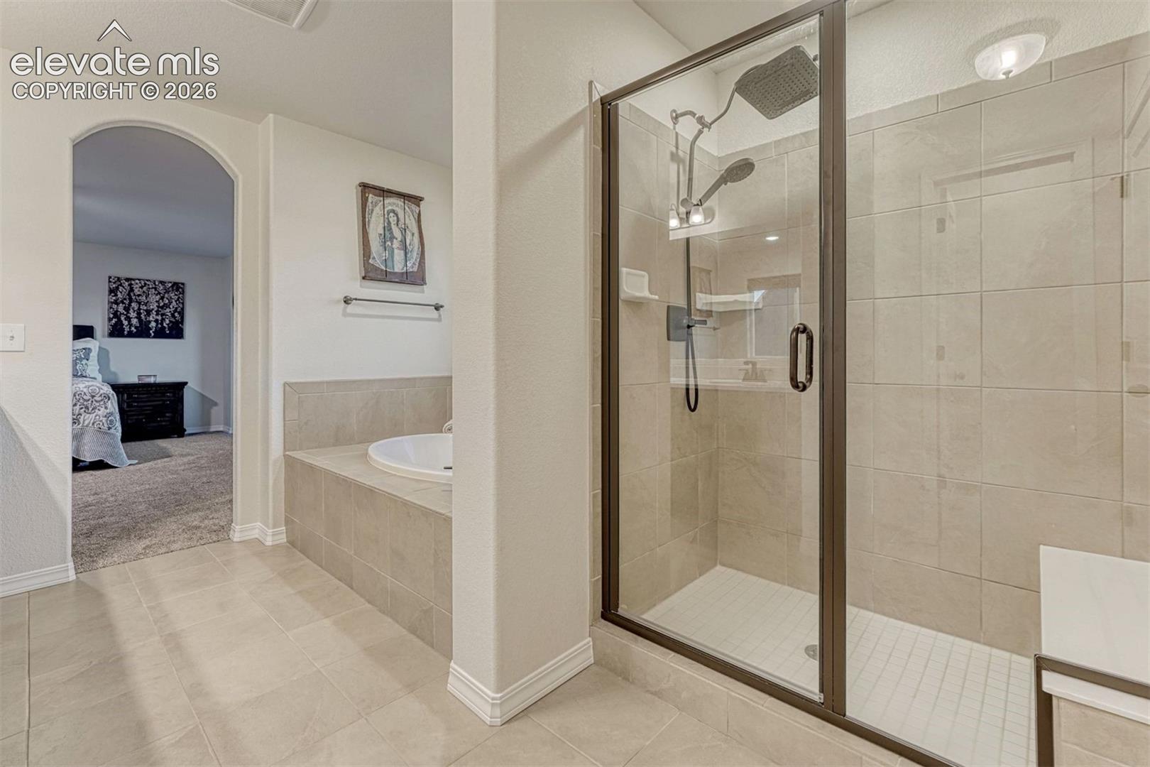 Spa shower with glass door and bench