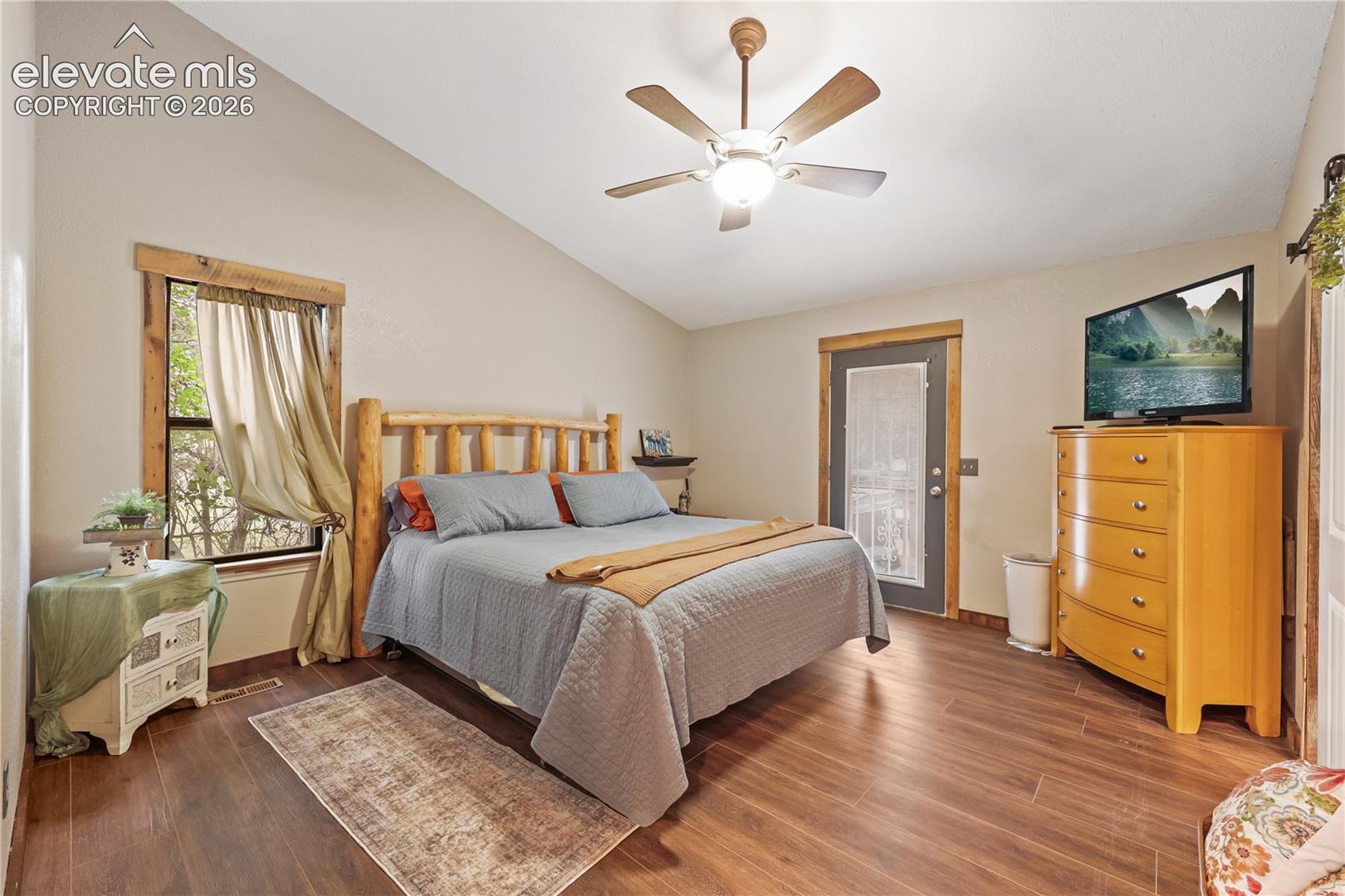 Primary bedroom with door to the deck and hot tub!