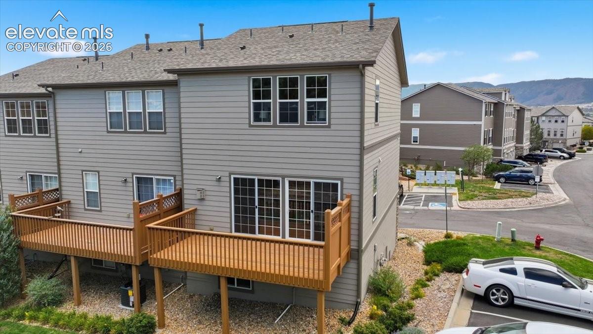 Multi-level property with light siding, private wood decks, and sliding glass doors