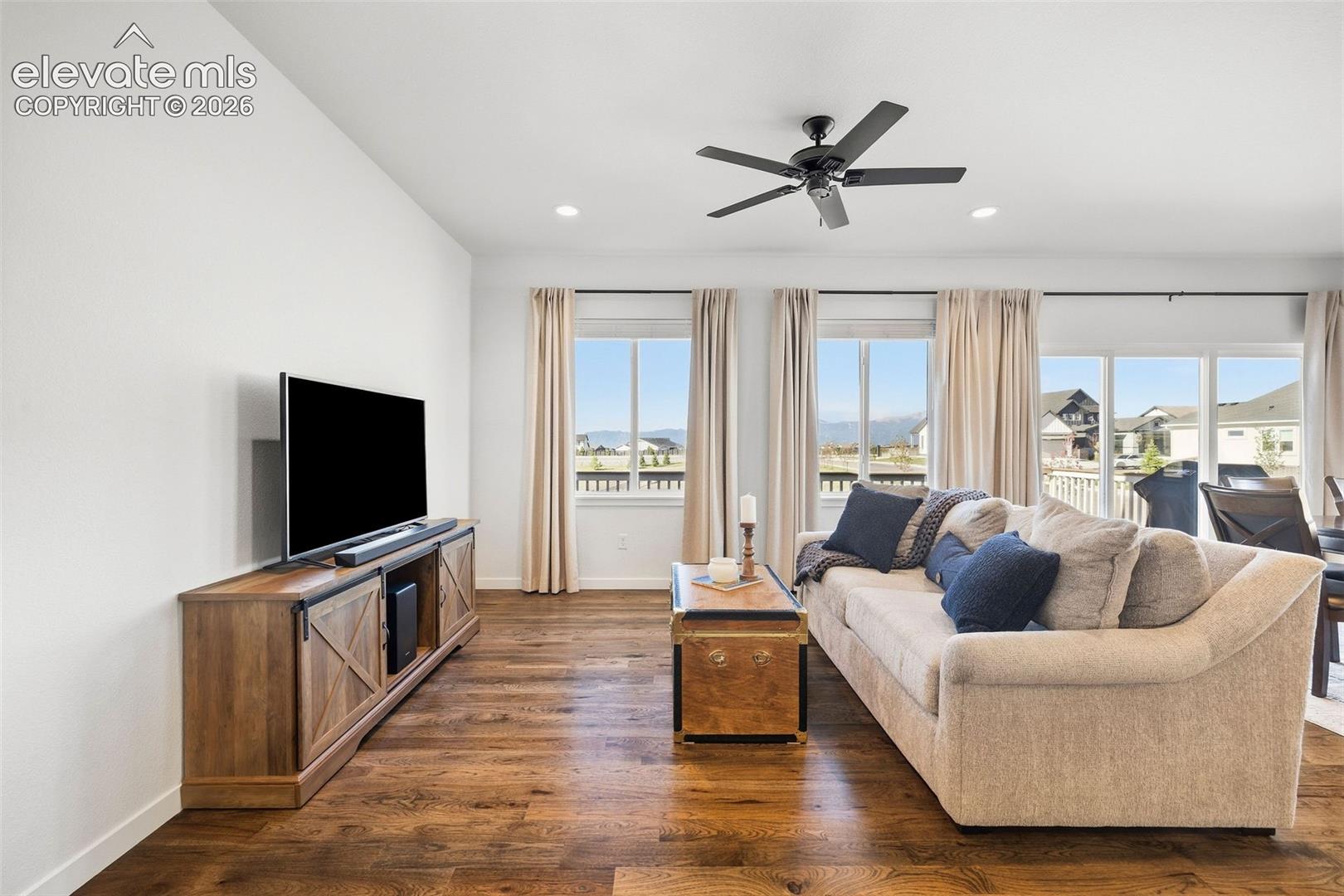 This living room is all about the views! Real wood hardwood flooring and access to the deck make it a wonderful place to relax. 