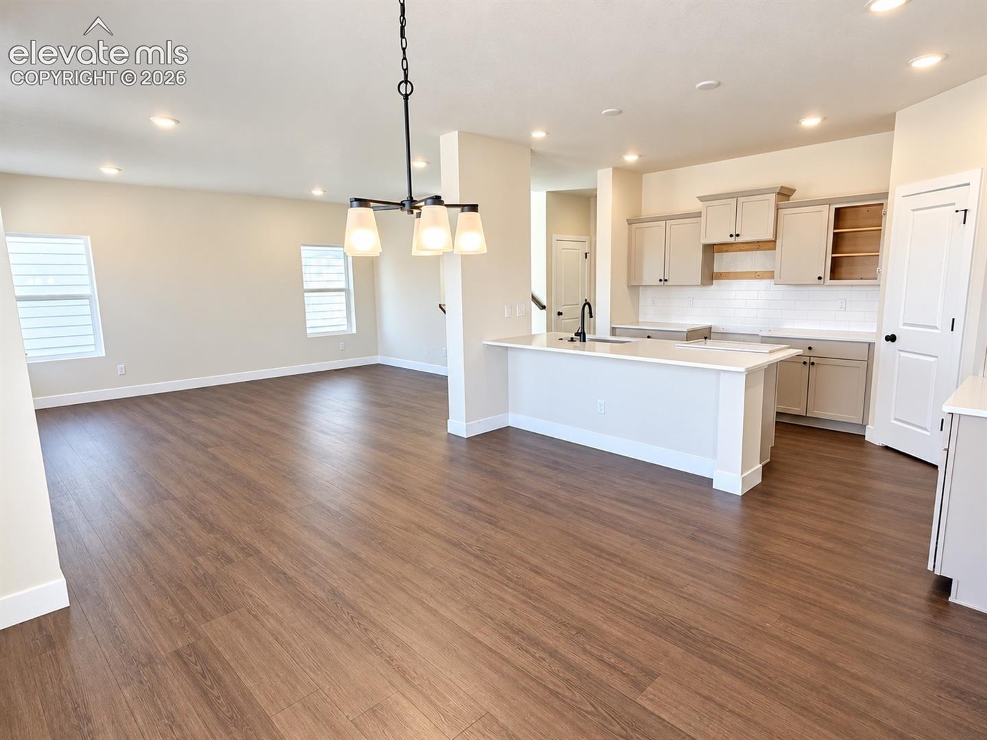 Open-concept living space with wood-finish flooring