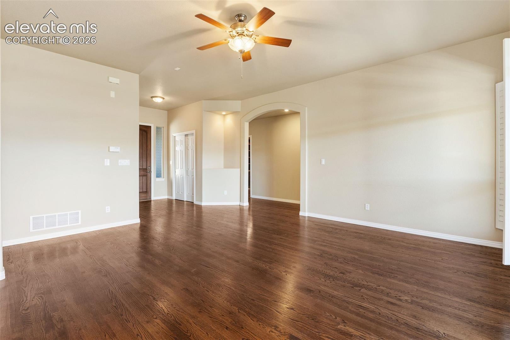 SPACIOUS LIVING ROOM HAS BEAUTIFUL HARDWOOD FLOORS