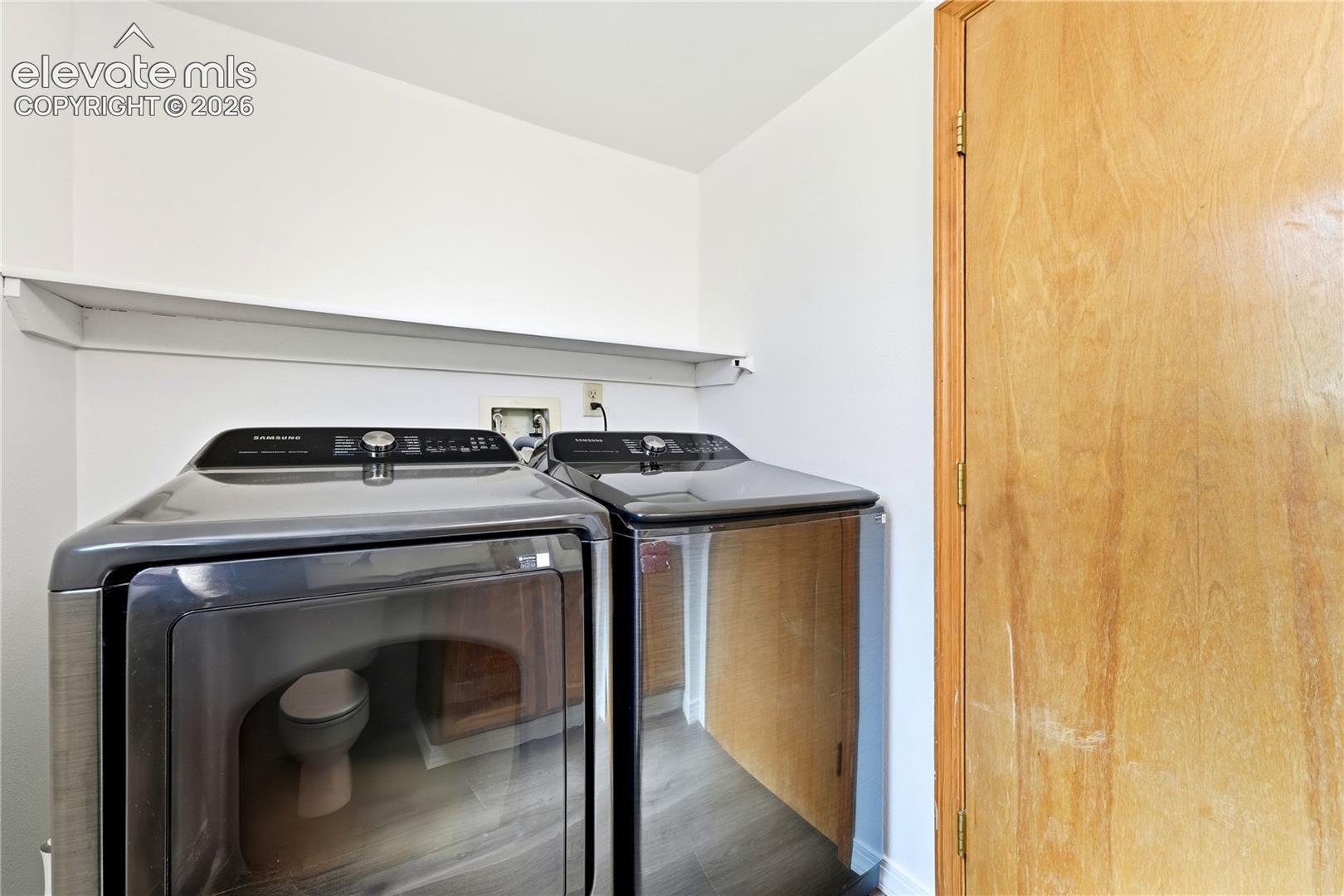 Laundry area on the main level in the half bath with shelf