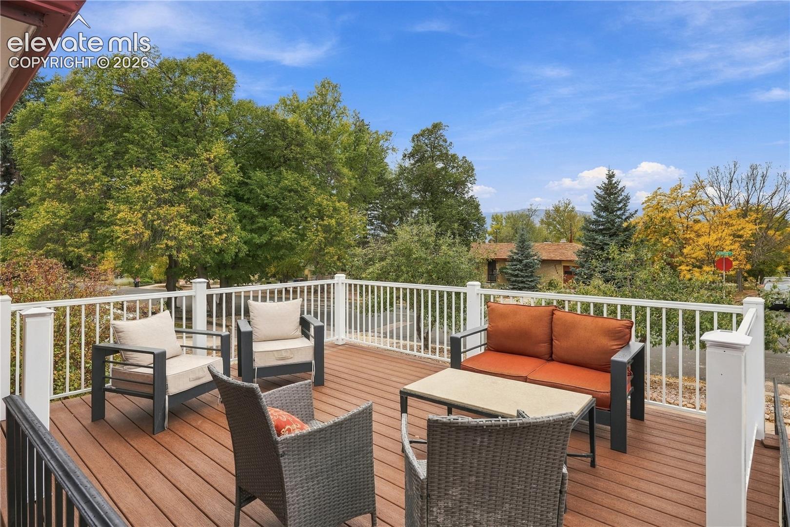 Elevated deck featuring composite planking and white metal balustrade railings
