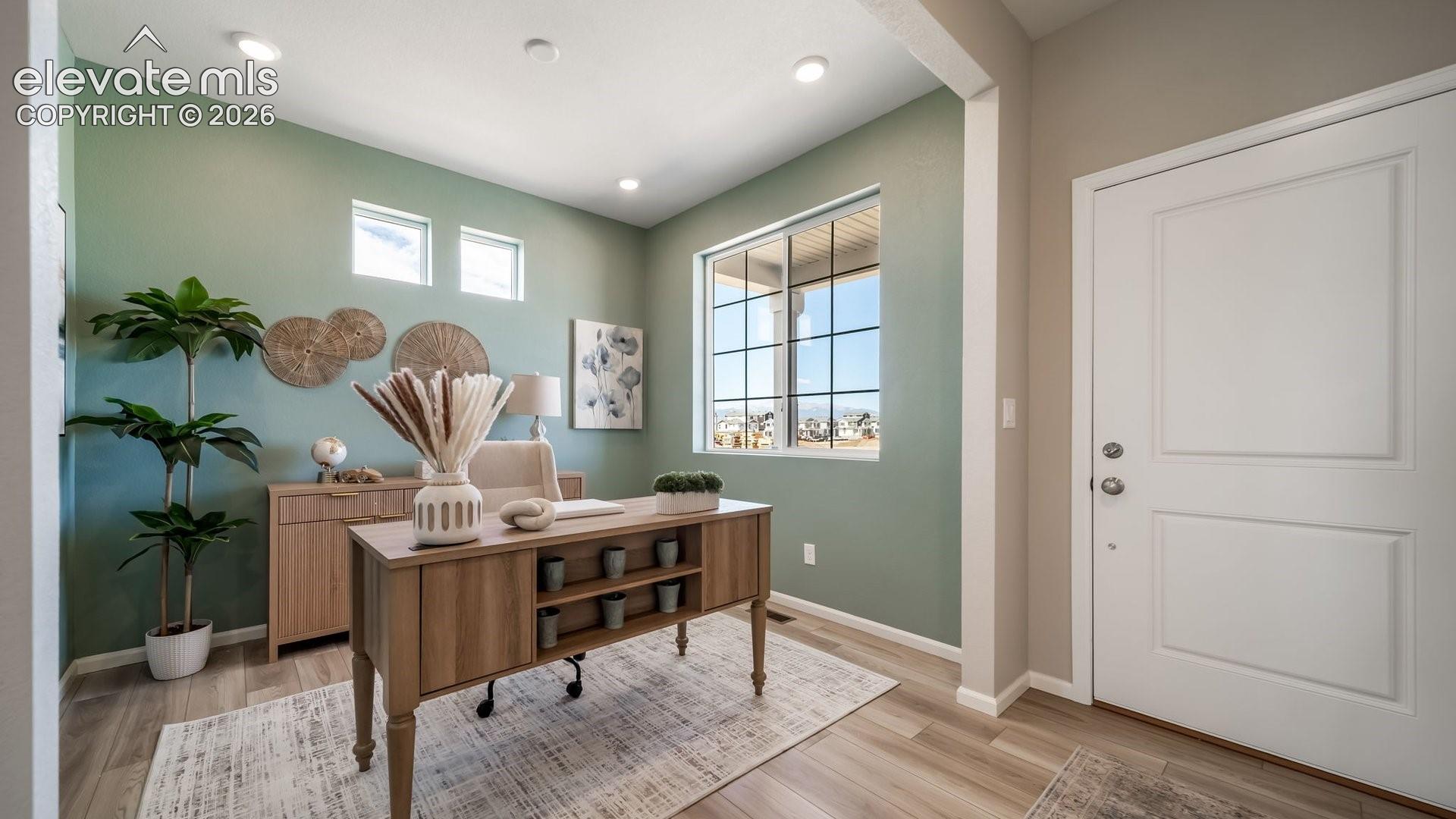 Recessed lighting fixtures, multiple windows for natural light, wood-finish flooring, and crisp white trim
*photos of a model home*