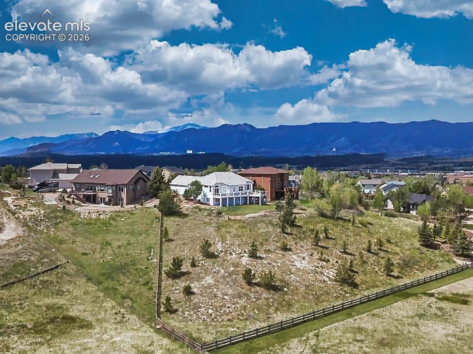 Impressive rear elevation showcasing fenced corner and back of the property, spacious backyard.