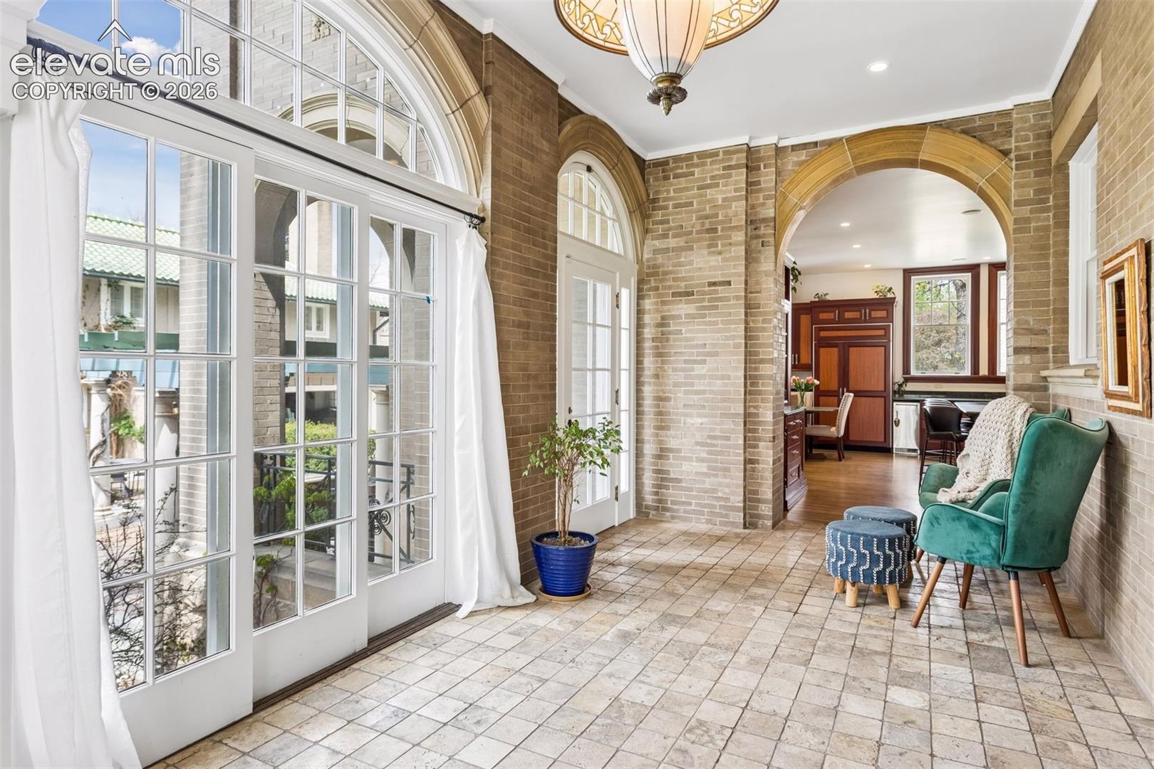 Sunroom off of kitchen and dining room leading to veranda