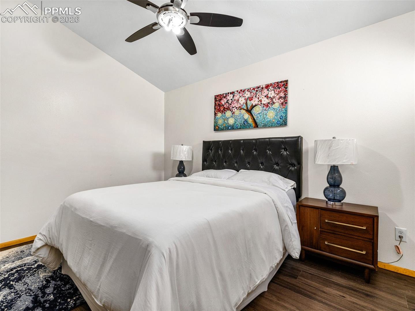 Bedroom featuring a ceiling fan and dark wood-style floors