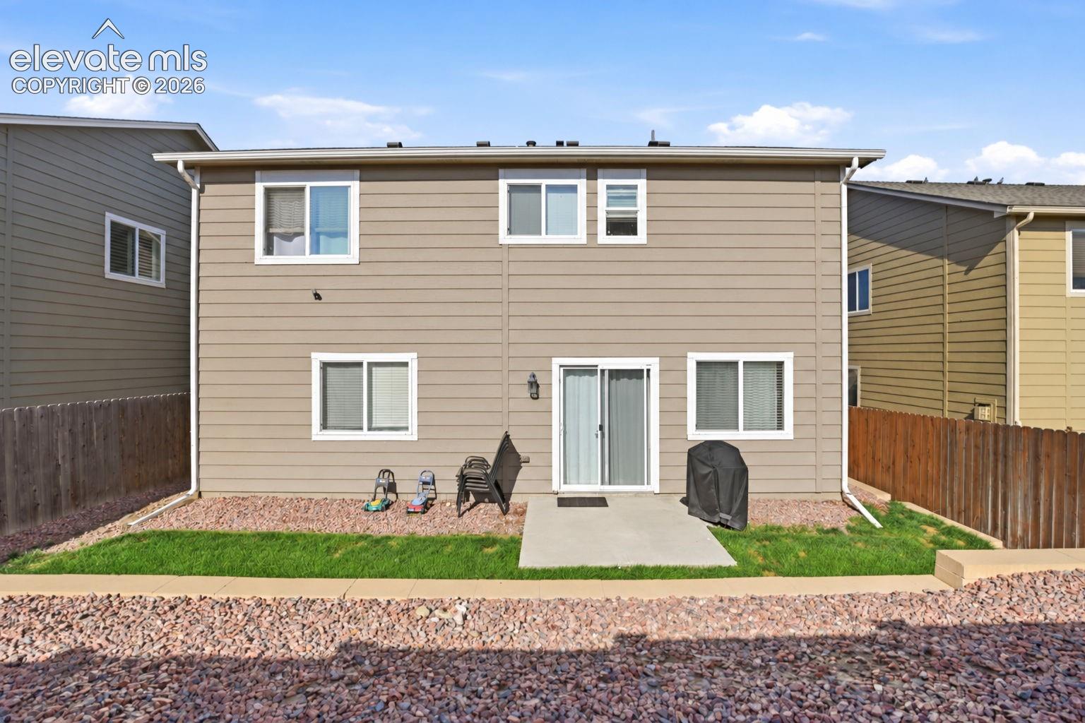 Rear exterior with vinyl siding and multiple windows