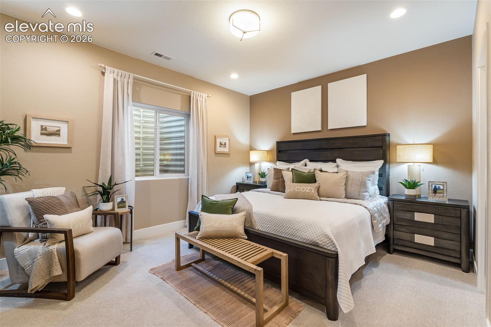 Neutral-toned walls, recessed lighting, ceiling-mounted fixture, and carpeting