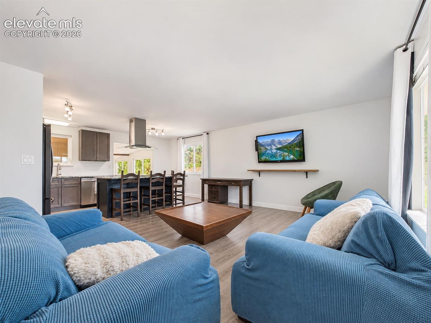 The living room flows directly into the remodeled kitchen, creating an open, connected layout well suited for everyday living and entertaining.