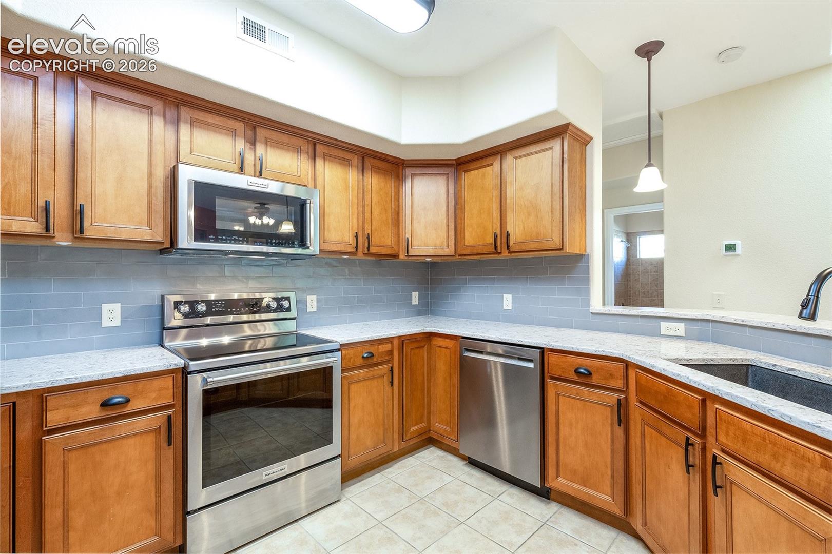 Granite countertops and tile backsplash
