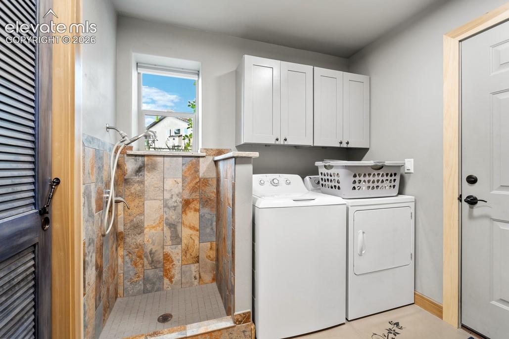 Built-in shower with natural stone-look tile surround and mosaic floor