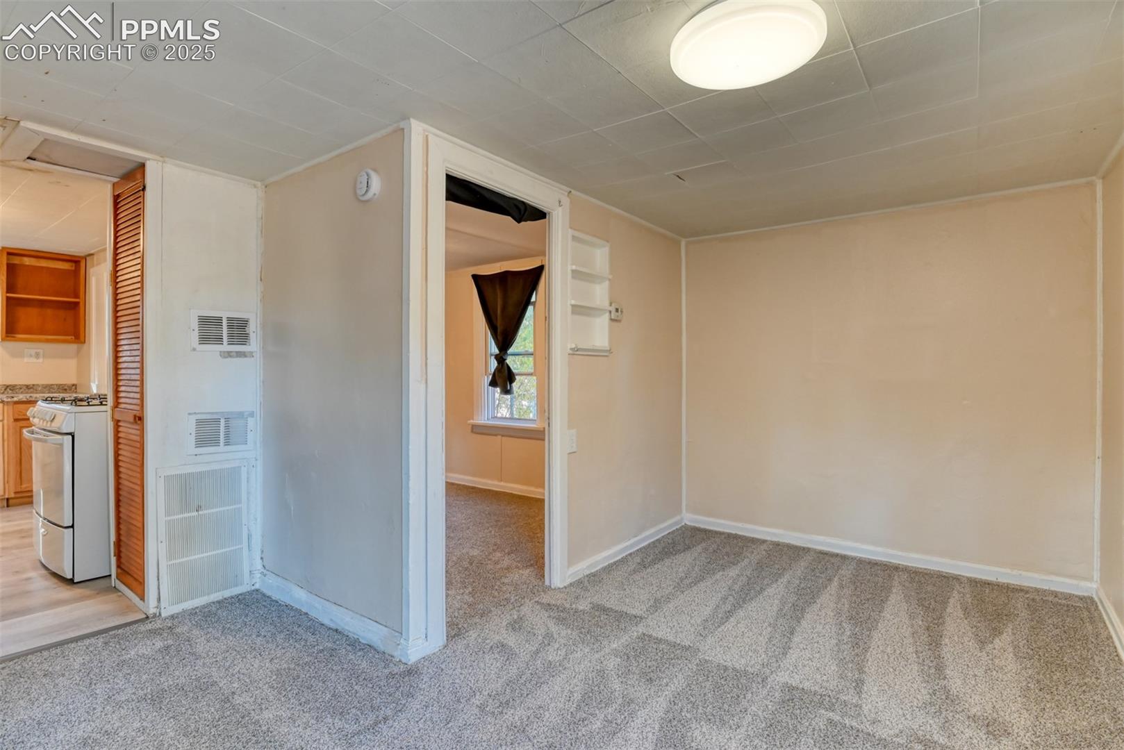 Cottage living room with access to bedroom and kitchen